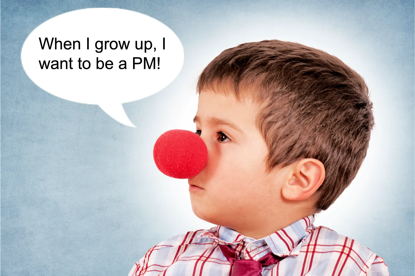 Boy wearing a red clown nose, with a speech bubble: When I grow up, I want to be a PM!