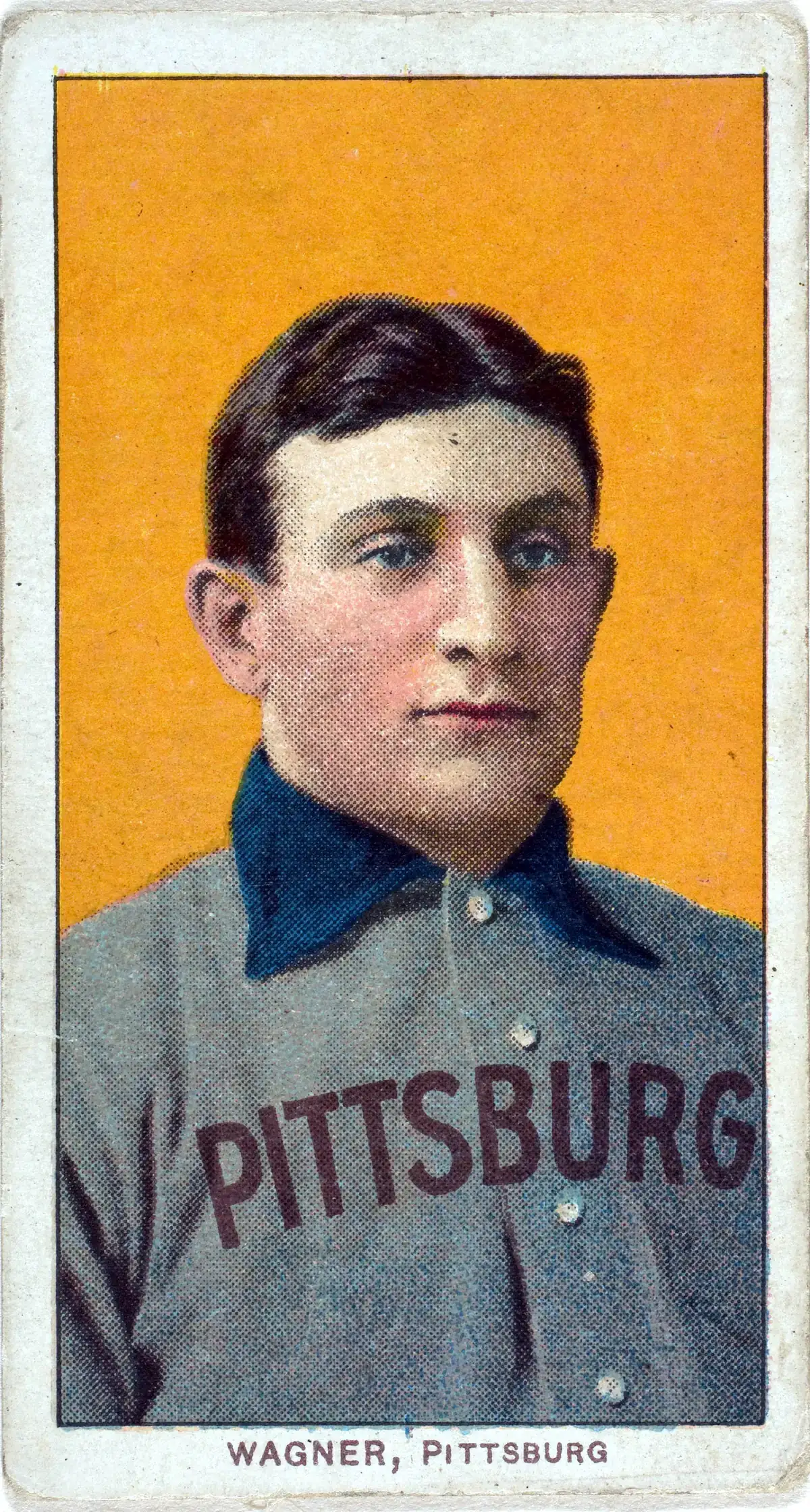 T206 Honus Wagner baseball card showing Wagner in a Pittsburg jersey against an orange background